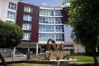 a statue in front of a building at Apartamento con TERRAZA en Burela in Burela de Cabo