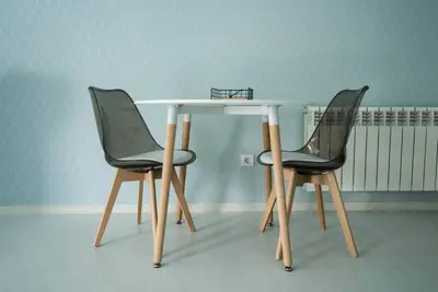 a white table with two black chairs around it at Apartamento con TERRAZA en Burela in Burela de Cabo