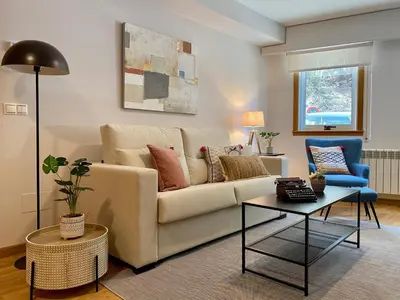 a living room with a couch and a table at Andainas C in Milladoiro