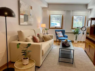 a living room with a couch and a chair at Andainas C in Milladoiro