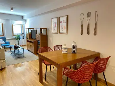 a living room with a dining room table and chairs at Andainas C in Milladoiro