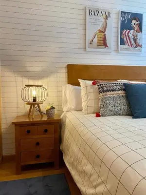 a bedroom with a bed and a table with a lamp at Andainas C in Milladoiro