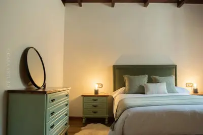 a bedroom with a bed with a mirror and a dresser at Casa Arturo in Tríacastela