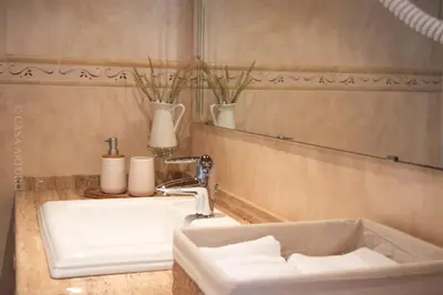 a bathroom with a white sink and a mirror at Casa Arturo in Tríacastela