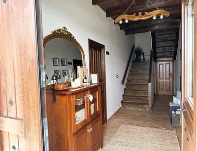 a room with a hallway with a mirror and a staircase at Casa Arturo in Tríacastela
