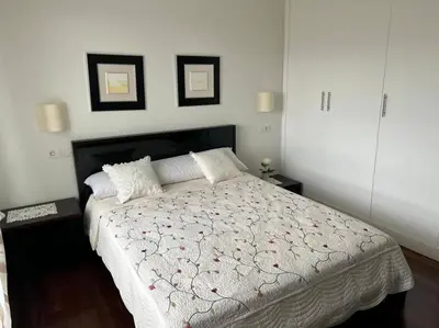 a bedroom with a large bed with two pillows at Excepcional chalet en Perbes. in Miño