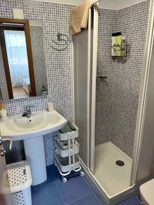 a bathroom with a shower and a sink at Playa Miño in Miño