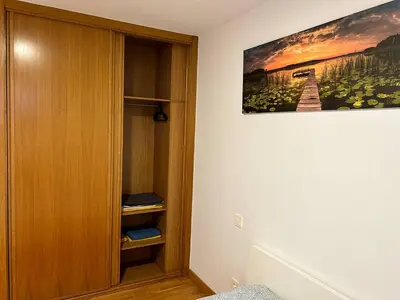 a room with a book shelf and a painting on the wall at Playa Miño in Miño