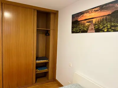 a room with a book shelf and a painting on the wall at Playa Miño in Miño