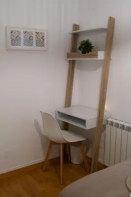 a desk and a chair in a room at Muralla de Tata in Lugo