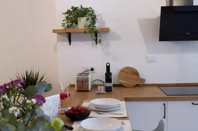 a kitchen with a table with a bottle of wine at Muralla de Tata in Lugo