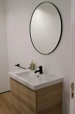 a bathroom with a sink and a mirror on the wall at Muralla de Tata in Lugo