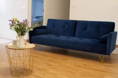 a blue couch in a living room with a table at Muralla de Tata in Lugo