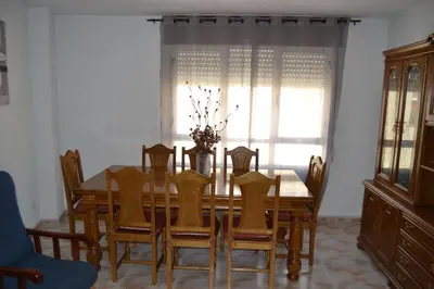 a dining room table and chairs with a window at Inmoinsuas Plaza de Galicia 32 in Sarria