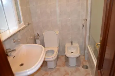 a bathroom with a sink and a toilet and a tub at Inmoinsuas Plaza de Galicia 32 in Sarria
