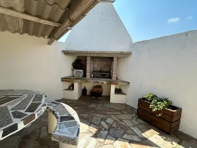 a patio with an outdoor fireplace in a building at Casa Pancha in Ribadeo