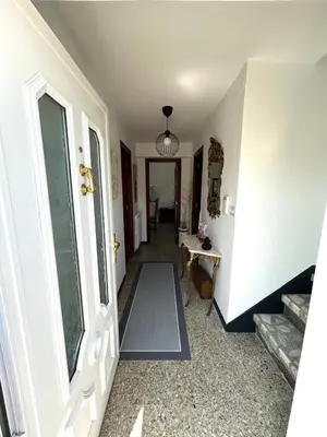a hallway of a home with a door and a table at Casa Pancha in Ribadeo