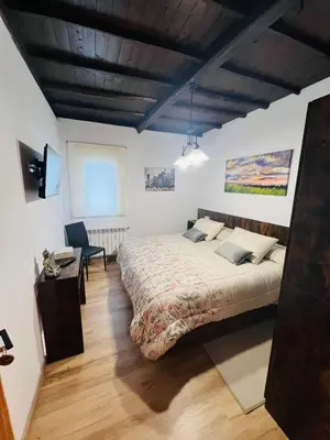 a bedroom with a bed and a desk in a room at A CASA DO LUGAR in Sampaio