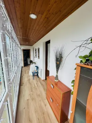 a hallway with a wooden ceiling and a dresser at A CASA DO LUGAR in Sampaio
