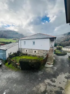 a white building with a staircase next to a driveway at A CASA DO LUGAR in Sampaio