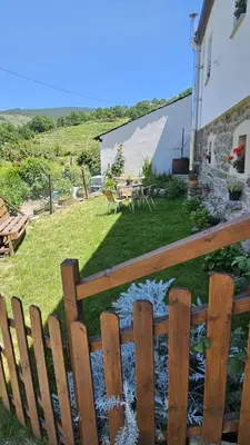 a garden with a wooden fence and a pond at A CASA DO LUGAR in Sampaio