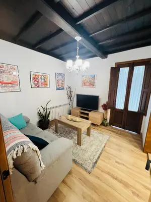 a living room with a couch and a tv at A CASA DO LUGAR in Sampaio