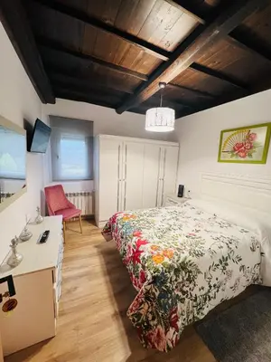 a bedroom with a bed and a desk in it at A CASA DO LUGAR in Sampaio