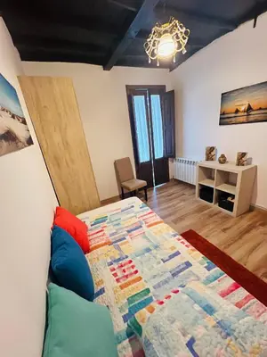 a bedroom with a bed with a quilt on it at A CASA DO LUGAR in Sampaio