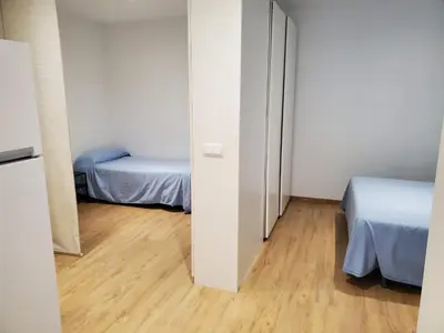 a small room with a bed and a mirror at BAHíA APARTAMENTOS TURÍSTICOS in Foz