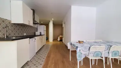 a kitchen with a table and chairs in a room at BAHíA APARTAMENTOS TURÍSTICOS in Foz