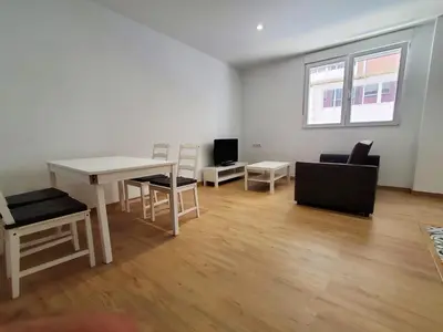a living room with a white table and chairs at BAHíA APARTAMENTOS TURÍSTICOS in Foz