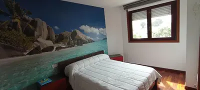a bedroom with a mural of the ocean at EnBURELA LUJO Y PLAYA in Burela de Cabo
