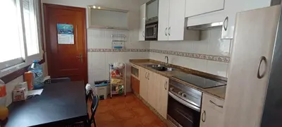 a small kitchen with a sink and a stove at EnBURELA LUJO Y PLAYA in Burela de Cabo