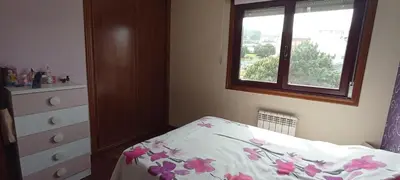a bedroom with a bed with a dresser and a window at EnBURELA LUJO Y PLAYA in Burela de Cabo