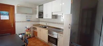 a kitchen with white cabinets and a sink and a stove at EnBURELA LUJO Y PLAYA in Burela de Cabo