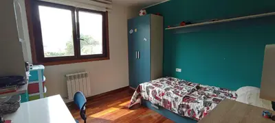 a bedroom with a bed and a green wall at EnBURELA LUJO Y PLAYA in Burela de Cabo