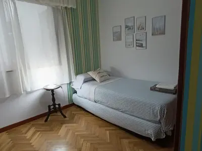 a small bedroom with a bed and a table at Marusia in Viveiro