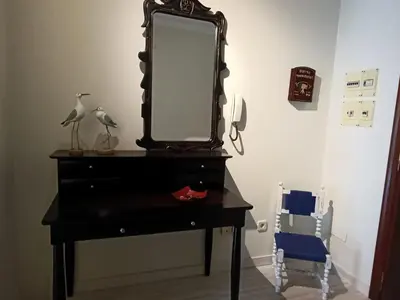 a black dresser with a mirror on top of it at Marusia in Viveiro