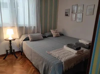 a bedroom with two twin beds and a lamp at Marusia in Viveiro