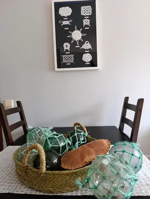 a basket of yarn on a table with two chairs at Marusia in Viveiro