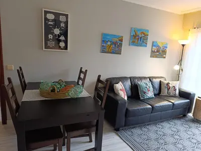 a living room with a couch and a table at Marusia in Viveiro