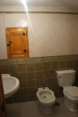 a bathroom with a toilet and a sink at Casa Rural de montaña en LUARCA ASTURIAS in Busindre