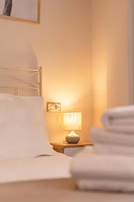 a bedroom with a bed and a lamp on a night stand at Pensión O Camiño in Sarria