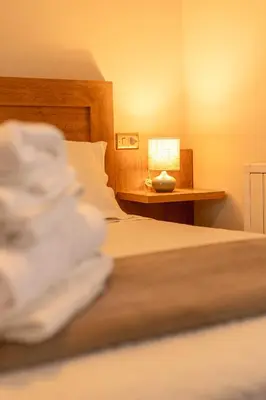 a bedroom with a bed and a lamp on a table at Pensión O Camiño in Sarria