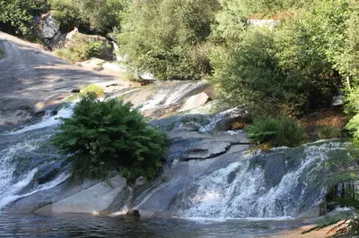 a waterfall in the middle of a river at Casa da Alfóndega in Caldas de Reis