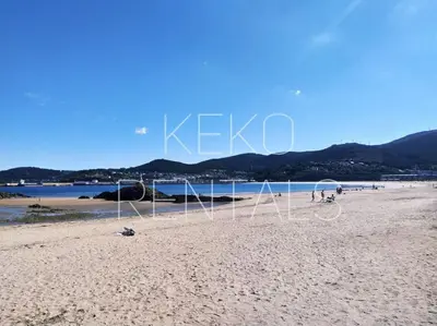 a group of people on a sandy beach at A Ledicia de Ana in Viveiro