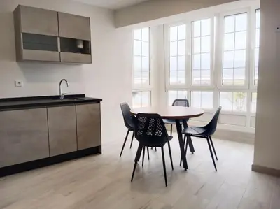 a kitchen with a table and chairs in a room at A Ledicia de Ana in Viveiro