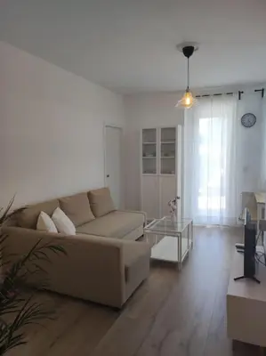 a living room with a couch and a glass table at Casa Dina II. in Carballino