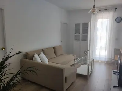 a living room with a couch and a glass table at Casa Dina II. in Carballino