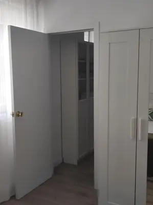 an empty room with white walls and an open door at Casa Dina II. in Carballino